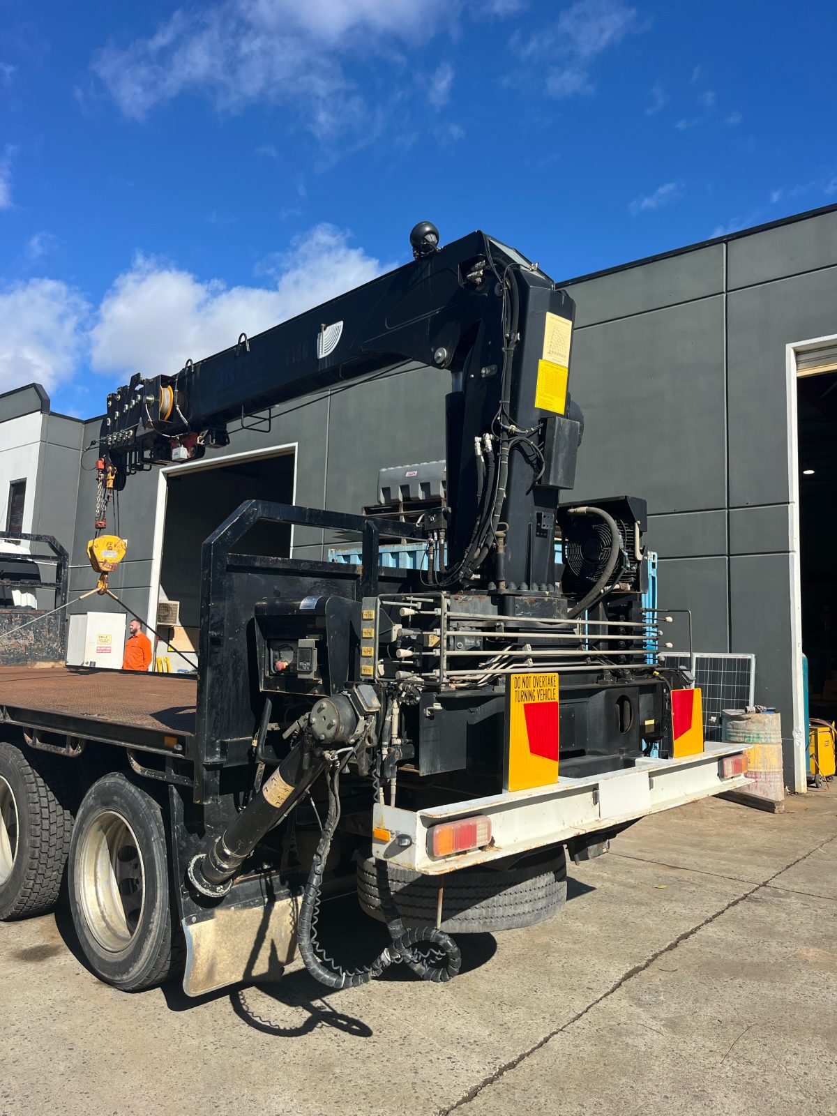 Crane mounted behind the truck cab