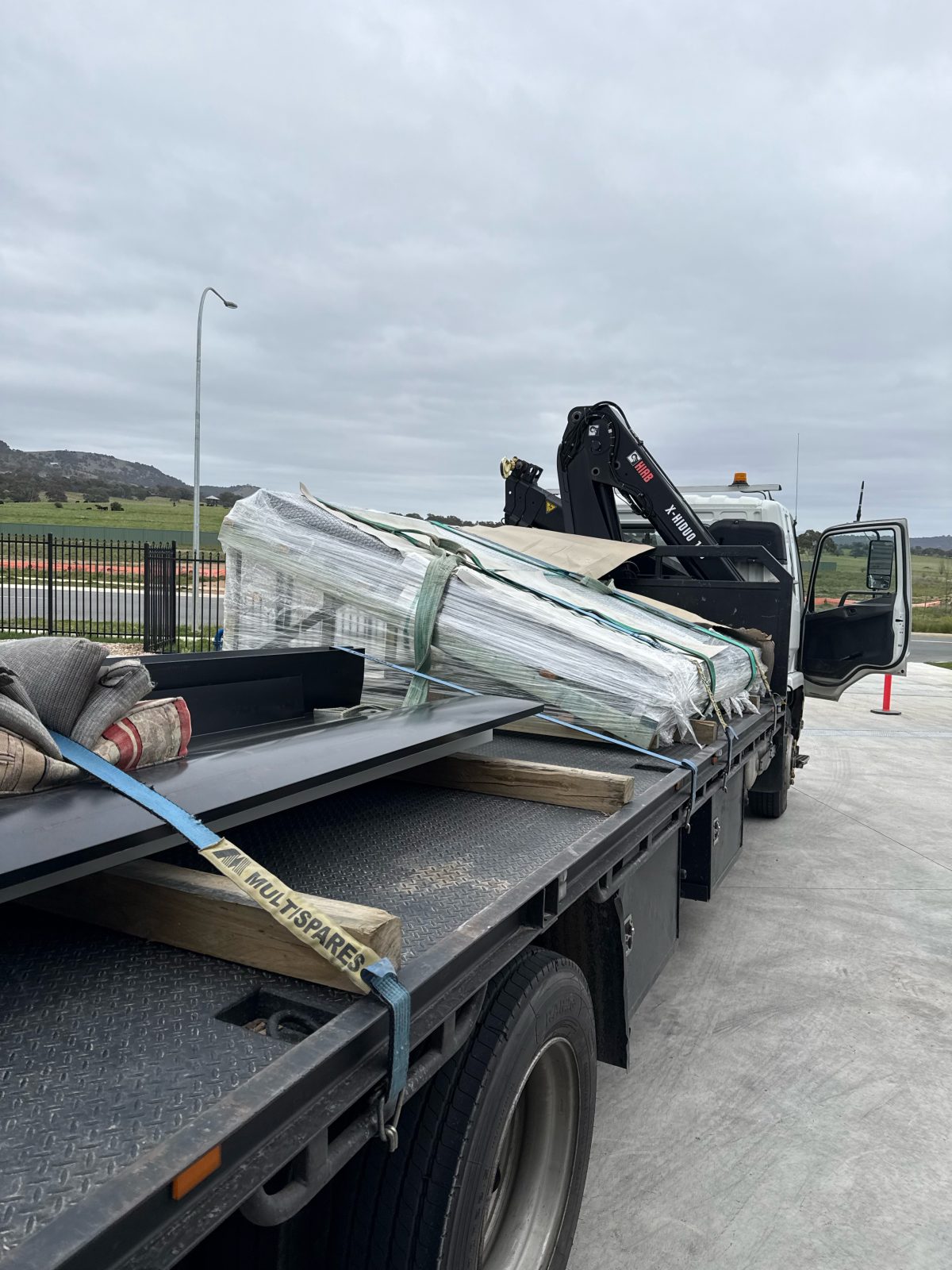 Load strapped down on a crane truck tray