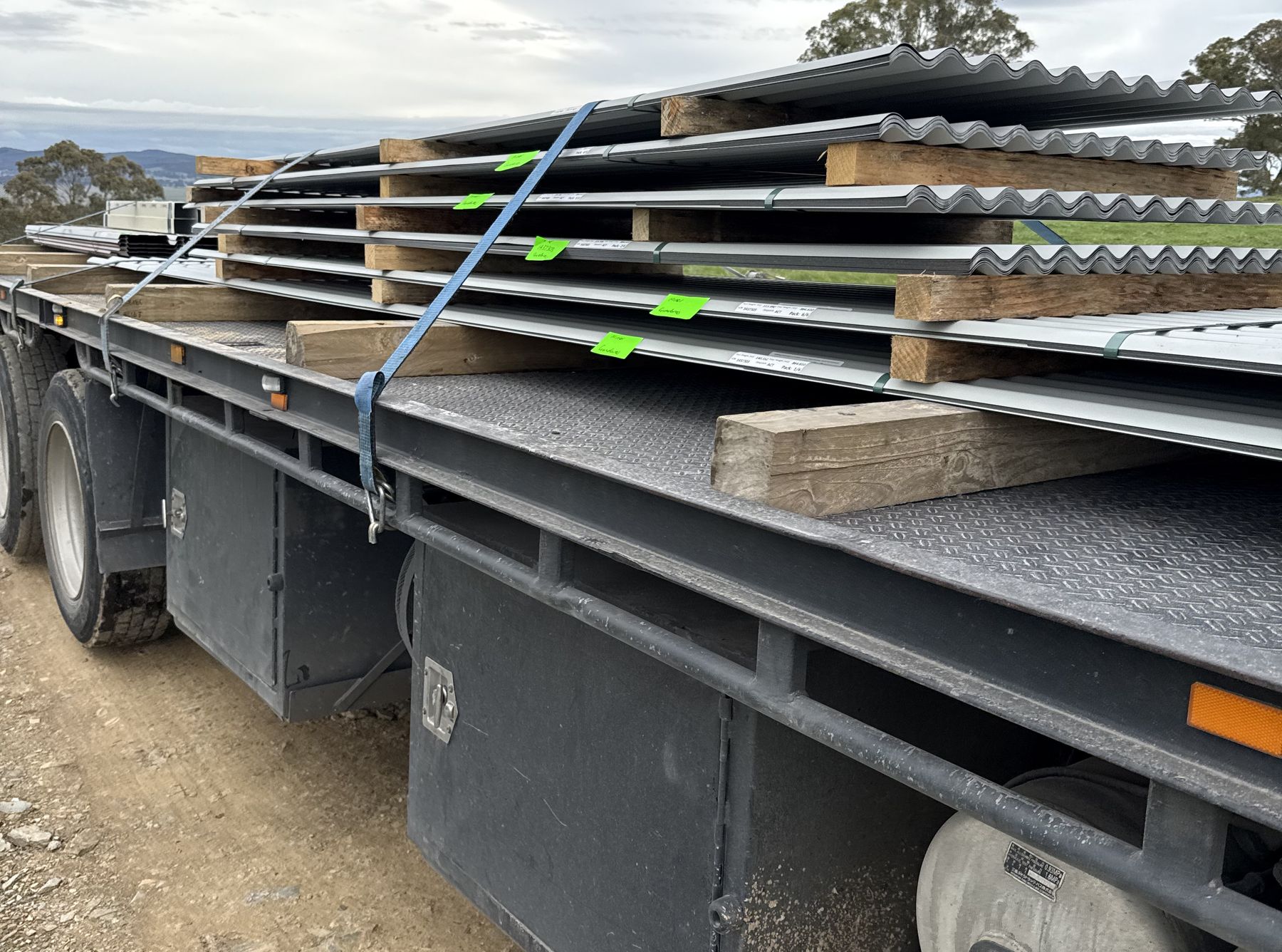 Corrugated sheets strapped down on a crane truck tray