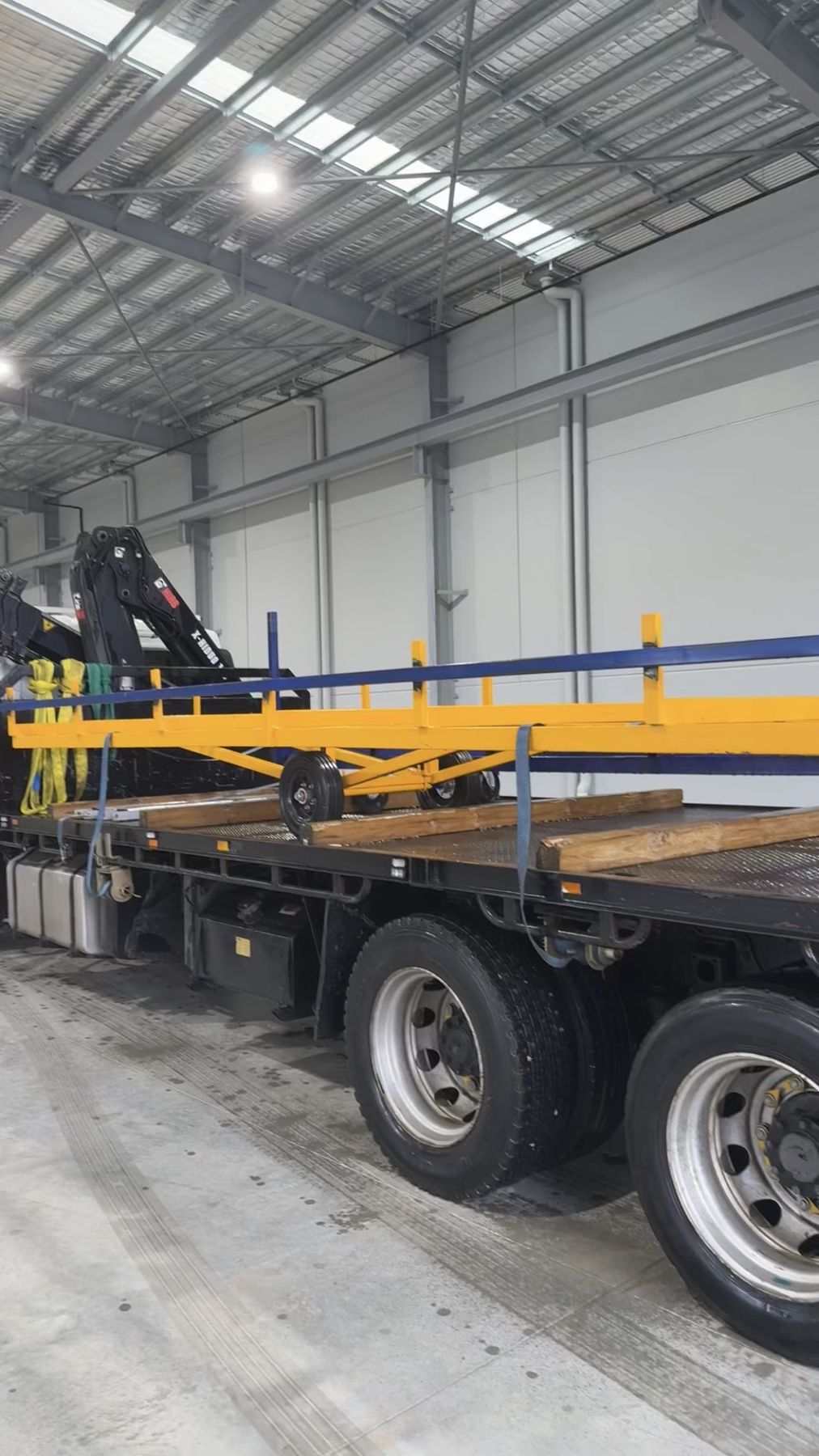 Crane truck carrying site equipment in a warehouse